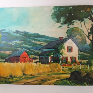 May include: Oil painting of a rural landscape featuring a white house with red shutters and a red barn. A field of hay and a dirt road are in the foreground, with rolling hills in the background. The painting is signed "Shumaker".