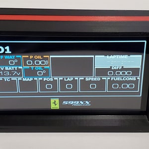 May include: A black dashboard display with a red trim, showing various data points including water temperature, oil pressure, battery voltage, and lap time. The display also shows the text "D1" and "599XX".