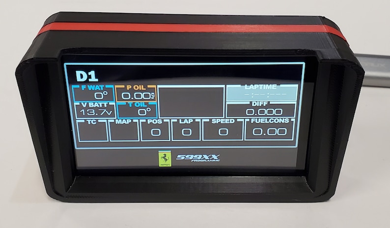 May include: A black dashboard display with a red trim, showing various data points including water temperature, oil pressure, battery voltage, and lap time. The display also shows the text "D1" and "599XX".