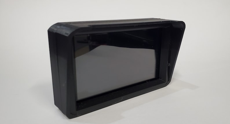 May include: A black plastic monitor with a sunshade. The monitor has a black screen and a rectangular shape.