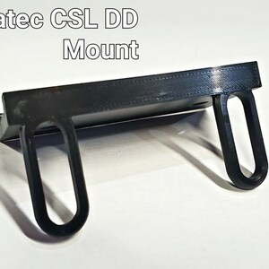 May include: A black 3D printed mount for a Fanatec CSL DD racing wheel.