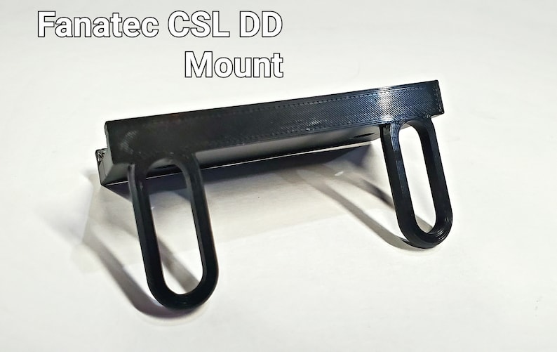 May include: A black 3D printed mount for a Fanatec CSL DD racing wheel.