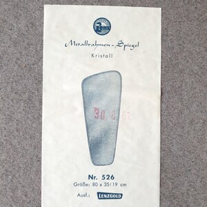 K&ouml;nnte beinhalten: A vintage paper advertisement for a mirror, with the text "Metallrahmen-Spiegel" and "Kristall." The image shows a stylized mirror shape with the numbers "30 6 61" and the dimensions 80 x 35/19 cm. The brand name "LENZGOLD" is also visible.