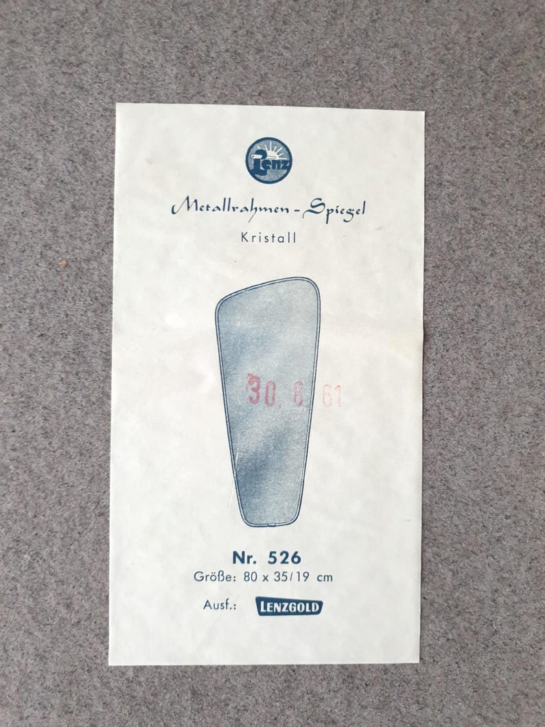 K&ouml;nnte beinhalten: A vintage paper advertisement for a mirror, with the text "Metallrahmen-Spiegel" and "Kristall." The image shows a stylized mirror shape with the numbers "30 6 61" and the dimensions 80 x 35/19 cm. The brand name "LENZGOLD" is also visible.