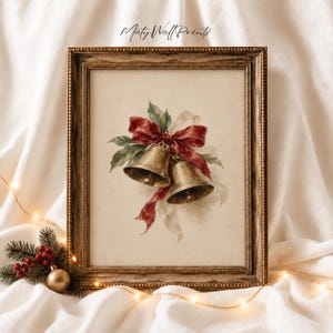 May include: A framed wall print featuring a watercolour illustration of two gold bells tied with a deep red ribbon and green holly leaves. The artwork is centred within a textured, dark gold frame, with the text Maty Wall Prints at the top.