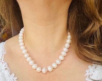 Pearl Necklace. Luxurious, vintage, classic necklace is assembled from very large white baroque freshwater pearls Natural cultured pearls