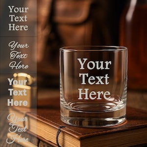 May include: A clear glass rocks glass with a thick base. The glass has the words "Your Text Here" etched into the side.