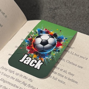 May include: Green bookmark with a colorful soccer ball graphic and the name "Jack" in white text. The background is a green watercolor splatter design.