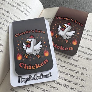 May include: Two magnetic bookmarks featuring a pixelated chicken design and the text "Charlie's Lava Chicken". One is dark grey, the other brown. One bookmark has the text "Magnetic Bookmark" at the bottom.