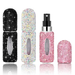 May include: A collection of bedazzled perfume atomizers in black, iridescent, and pink. Each atomizer is covered in sparkling rhinestones, with a spray nozzle and a matching cap. The designs are elegant and suitable for travel.