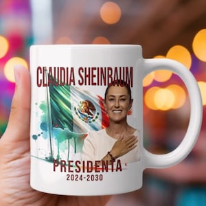 May include: White ceramic mug with a colorful image of a woman with a Mexican flag in the background. The text "CLAUDIA SHEINBAUM" and "PRESIDENTA 2024-2030" is printed on the mug.