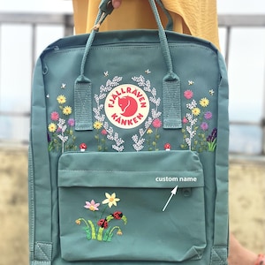 Fjallraven kanken backpack embroidered with ladybugs and colorful flowers, Ladybug embroidery design on Fjallraven Kanken backpack