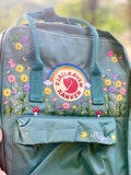 Hand Embroidery on Fjallraven Kanken Backpack with Flowers and rainbow | Kanken Backpack Embroidered with Flower and  Rainbow product logo