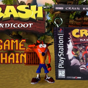May include: A keychain featuring a miniature replica of the PlayStation game Crash Bandicoot. The keychain is made of plastic and features a 3D model of Crash Bandicoot, the game's main character. The keychain is attached to a silver metal ring.