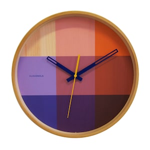 An art piece and timepiece in one. The red Flor wall clock is warm and welcoming, yet modern and minimal, all at the same time. Solid natural wood frame. Pop of color via the vibrant printed face and contrasting hands. The definition of Dutch design.