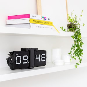 What you see is what you get! This metal flip clock from Cloudnola is impressive and
gives a glimpse into the mechanism of the clock. The industrial look evokes wonder and respect. The clock can stand or hang and uses 1 D battery.