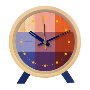 Brighten up any room with the Riso Alarm clock. Solid wood frame. Saturated graphic printed face in a mix of red and blue. An homage to the Risograph printing machine created in Japan in the 1980s. This silent clock will stand the test of time.