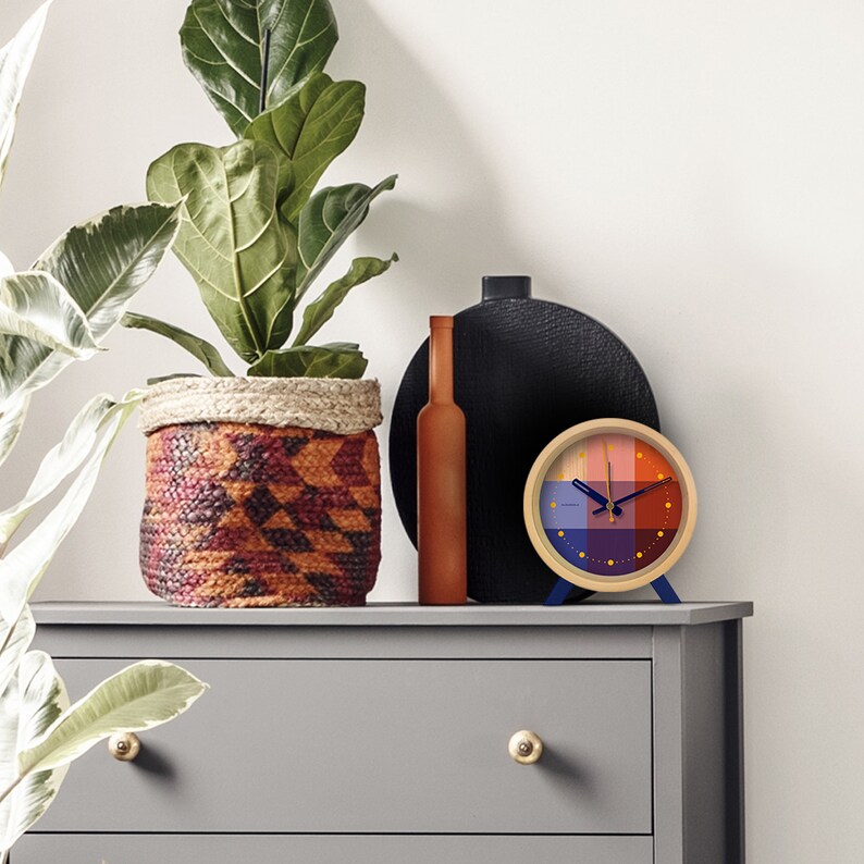 Brighten up any room with the Riso Alarm clock. Solid wood frame. Saturated graphic printed face in a mix of red and blue. An homage to the Risograph printing machine created in Japan in the 1980s. This silent clock will stand the test of time.