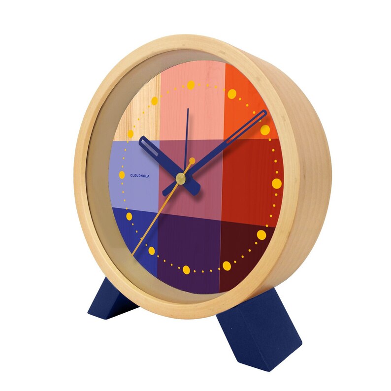 Brighten up any room with the Riso Alarm clock. Solid wood frame. Saturated graphic printed face in a mix of red and blue. An homage to the Risograph printing machine created in Japan in the 1980s. This silent clock will stand the test of time.