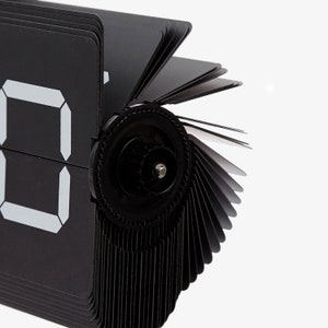 What you see is what you get! This metal flip clock from Cloudnola is impressive and
gives a glimpse into the mechanism of the clock. The industrial look evokes wonder and respect. The clock can stand or hang and uses 1 D battery.