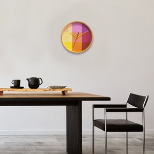 The pink and yellow riso clock pops on your wall like a trendy accent.