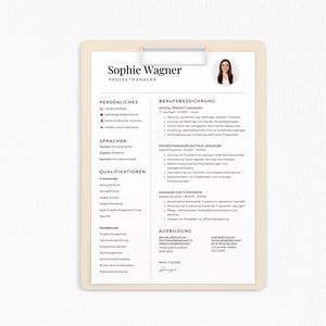 May include: A resume on a clipboard with the name "Sophie Wagner" at the top. The resume includes sections for personal information, languages, qualifications, and work experience. A photo of a woman is in the upper right corner.