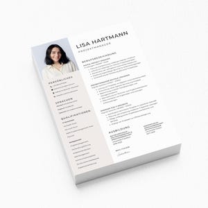 May include: A stack of white resume papers with the name "Lisa Hartmann" and the title "Projektmanager" at the top. A photo of a woman is in the upper left corner. The resume includes sections for personal information, languages, and qualifications.