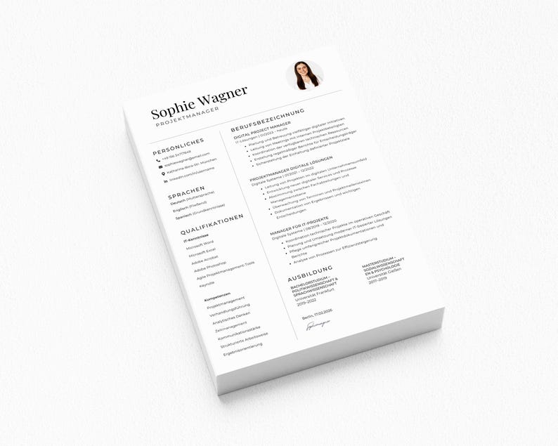 May include: A stack of white resume papers with black text. The top sheet features the name "Sophie Wagner" and the title "Projektmanager." A small headshot is in the upper right corner. The resume details experience, skills, and education.