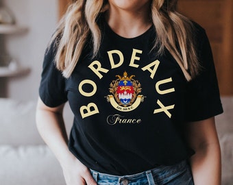 May include: Black t-shirt with a yellow graphic of the Bordeaux coat of arms and the text "Bordeaux France".