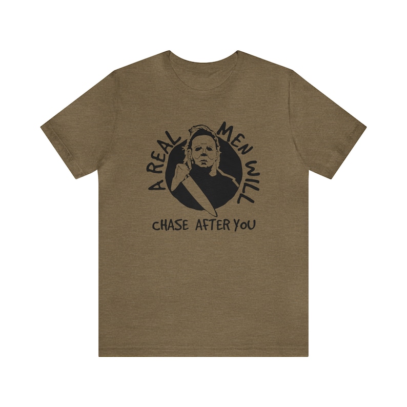 May include: A green t-shirt with a black graphic of a man with a knife and the text "A real men will chase after you".