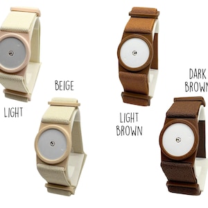 May include: Four circular sensor covers with elastic bands in light, beige, light brown, and dark brown colors. Each cover features a central white disc with a small metallic center. The text labels light, beige, light brown, and dark brown are visible.