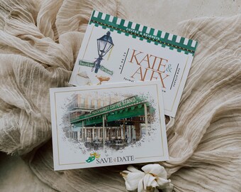 May include: Two rectangular paper cards featuring New Orleans themes. The top card displays a green and white striped awning, a street lamp, and the text Kate & Alex. The bottom card shows a watercolor image of the French Market Coffee Stand.