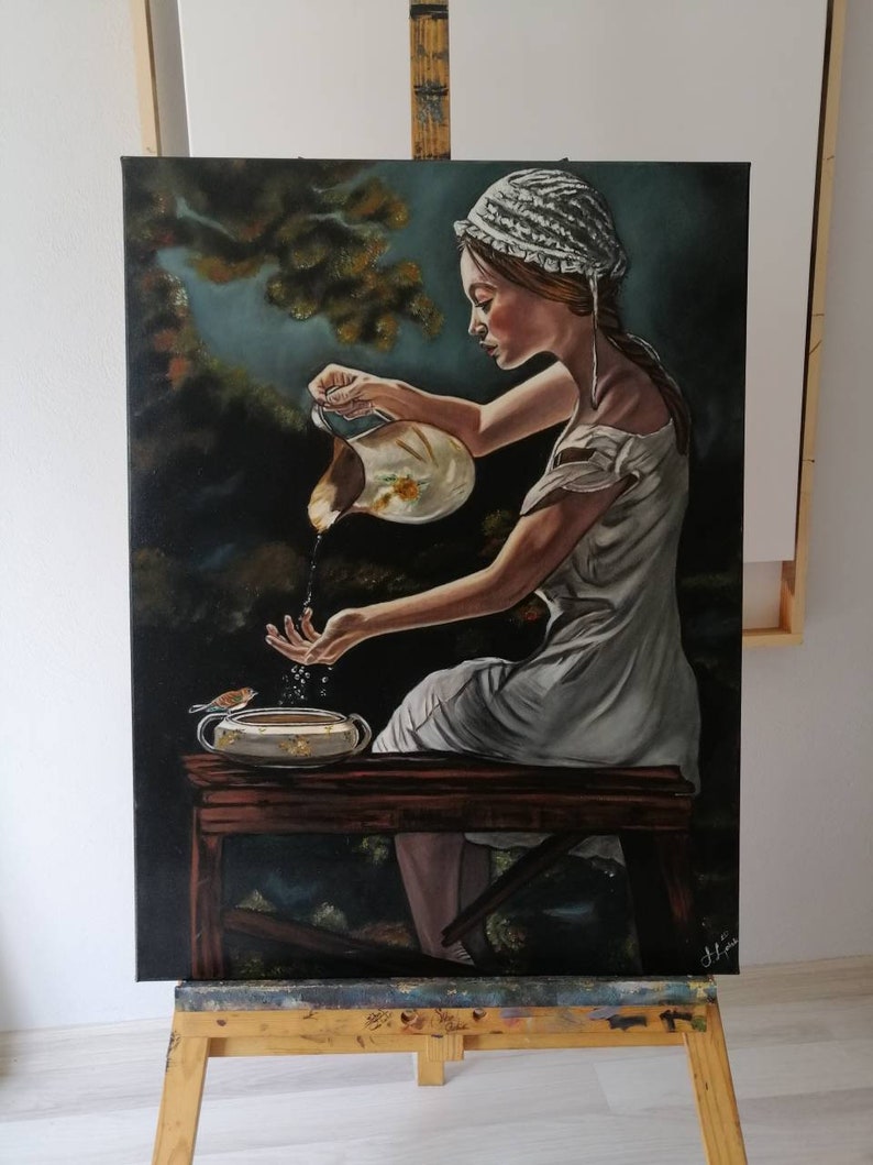 May include: A painting of a woman in a white dress and bonnet pouring water from a pitcher into a bowl. The woman is sitting on a wooden bench in a forest setting. The painting is done in a realistic style with a focus on detail.
