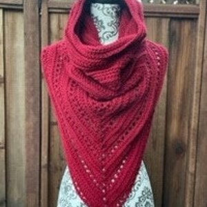 May include: A red crocheted cowl with a wide, gathered neckline. The cowl is made with a lacy stitch pattern and has a triangular shape.