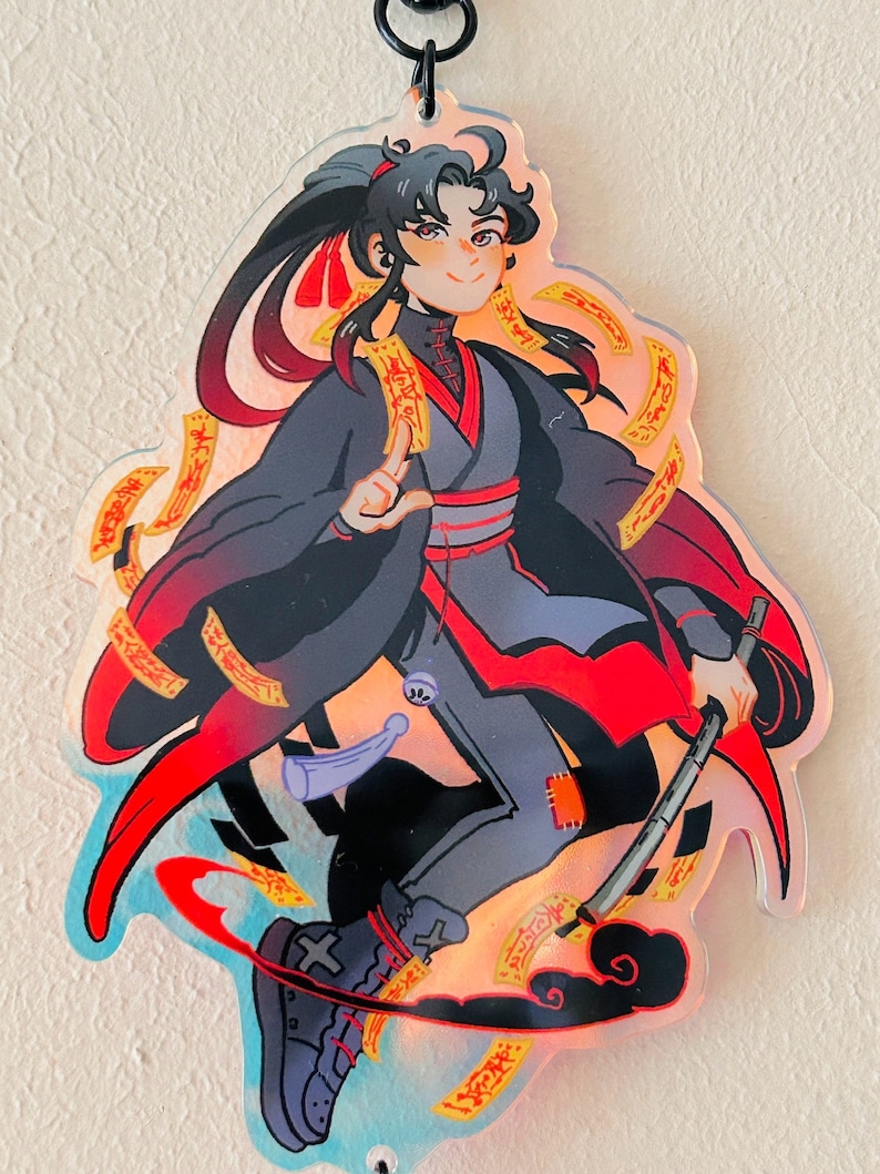 May include: A black and red anime character with long black hair and a red headband. The character is holding a long, thin, black and white weapon. The character is surrounded by yellow and orange swirls. The background is a light blue with white clouds.