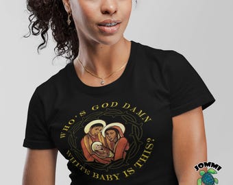 May include: Black t-shirt featuring a graphic of a religious scene with the text "WHO'S GOD DAMN WHITE BABY IS THIS?" in a circular design. The design includes a family with halos. The shirt also has a logo.