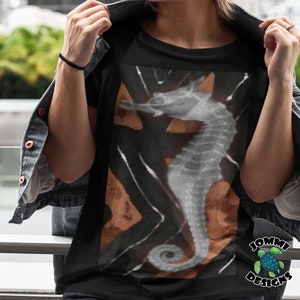 May include: Black t-shirt featuring a white and brown graphic of a seahorse. The graphic has a geometric pattern and a black background.