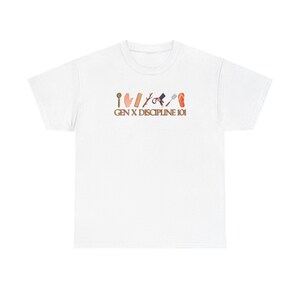 May include: White t-shirt with a brown graphic of various objects and the text "GEN X DISCIPLINE 101".