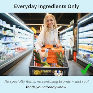Smiling woman grocery shopping with a full cart of produce, representing how the low sodium grocery list features only real, everyday foods.