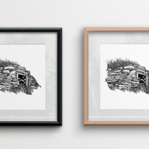 May include: Two framed black and white line drawings of a stone building with a doorway. The frames are black and natural wood.