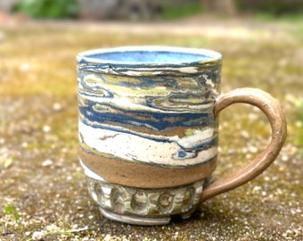 Ceramic wheel-thrown mug, 12oz, handmade marbling, non-toxic speckled clays, tan handle with blue, green, black and natural white body.