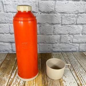 Vintage tall orange Thermos with insulated glass liner and cream cup