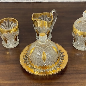 Vintage pinwheel style pressed glass six-piece serving set with gold accents