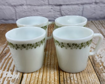 Set of four vintage Pyrex milk glass cups or mugs with green daisy flower design