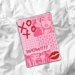 May include: A pink tablet case with a pop art design. The case features the words "XO" and "WOW!!!" in red, along with a retro illustration of a woman and a pair of red lips. The background is a pink grid pattern.