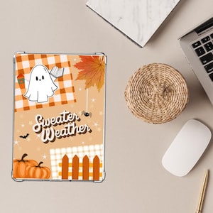 May include: A clear phone case with a collage of autumnal graphics. The design includes a cartoon ghost, pumpkins, a maple leaf, and the words "Sweater Weather" in a whimsical font. The background incorporates orange and white gingham patterns.
