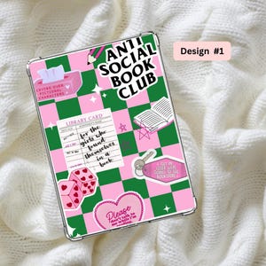 May include: A clear phone case with a pink and green checkered pattern. The case is decorated with stickers, including the text "Anti Social Book Club" and "Crying Over Fictional Characters." There's also a library card and dice.