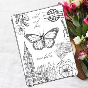 May include: A clear phone case with a black and white design featuring a butterfly, a clock tower, flowers, and the text "wild and free" and "ciao bella".