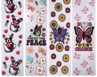 May include: Four sticker sheets with various designs. One features a bulldog in a teacup holding a heart, another has butterflies and the text "Protect Your Peace", a third has sunflowers and a butterfly, and the last has butterflies and the text "Be the Change".