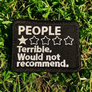 May include: Black patch with white embroidery that reads "PEOPLE" with a one-star rating and the text "Terrible. Would not recommend."